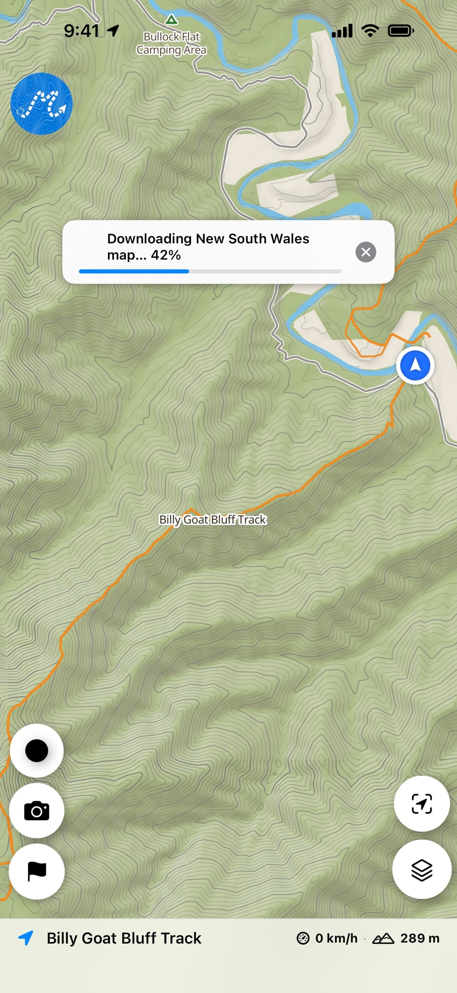 The map in Dirt Map with a banner showing a region’s map downloading, 42% done, with a button to cancel.