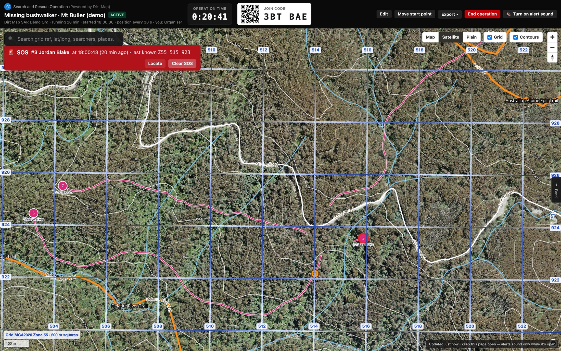 A close-up of the board on satellite imagery with a 200 m MGA2020 grid: three searchers’ trails across the ground, the searcher who raised an SOS, and a clue pinned where it was found.